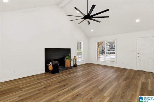 unfurnished living room with beamed ceiling, baseboards, wood finished floors, and a fireplace