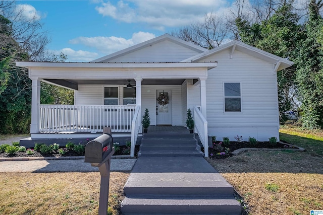 bungalow-style home featuring covered porch, metal roof, and ceiling fan