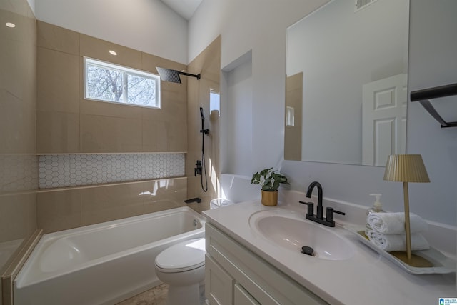 bathroom featuring shower / bathtub combination, toilet, and vanity