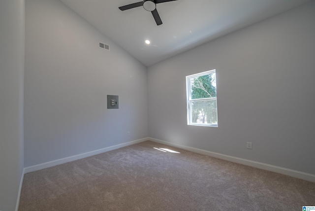 carpeted spare room with visible vents, ceiling fan, baseboards, and vaulted ceiling