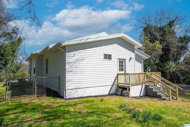 view of side of property featuring a gate, a yard, and fence