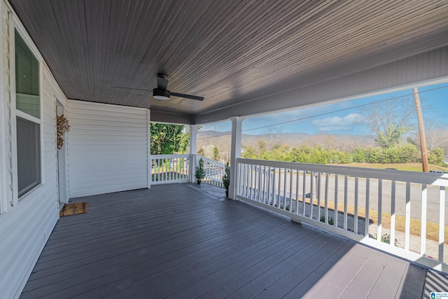 wooden deck featuring ceiling fan