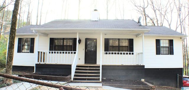 view of front of property with a porch and a shingled roof