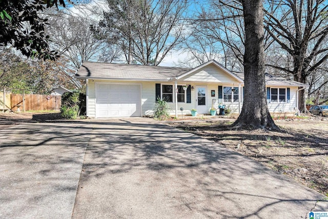 single story home with an attached garage, fence, and driveway