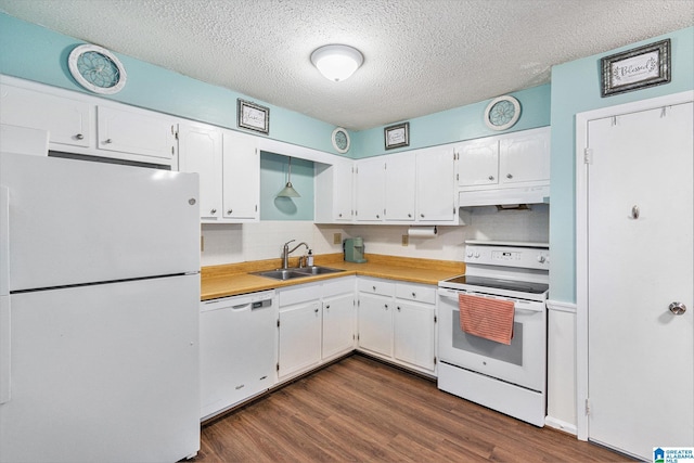 kitchen featuring a sink, white appliances, under cabinet range hood, and white cabinets