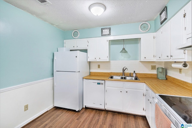 kitchen with dark wood-style floors, white appliances, white cabinetry, and a sink