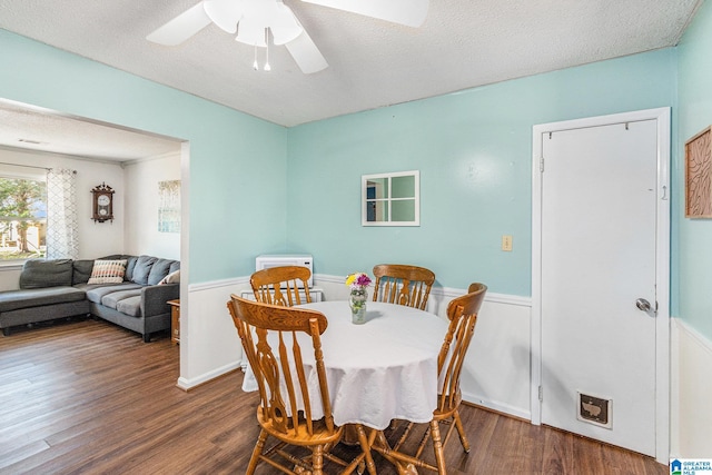 dining room featuring a textured ceiling, wood finished floors, and a ceiling fan