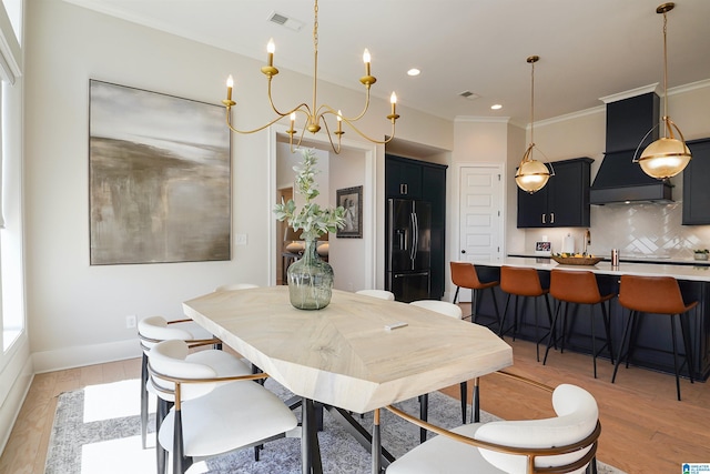 dining room with visible vents, crown molding, baseboards, recessed lighting, and light wood-style floors