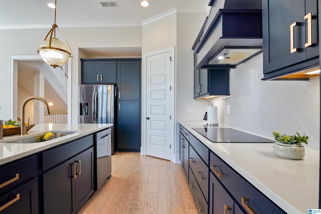 kitchen featuring a sink, appliances with stainless steel finishes, crown molding, and light countertops