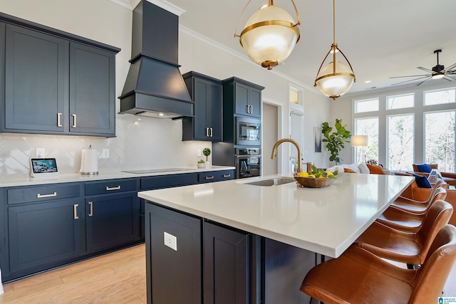 kitchen with ornamental molding, a sink, open floor plan, appliances with stainless steel finishes, and custom exhaust hood