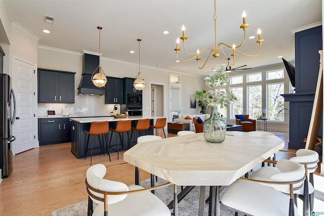 dining space featuring visible vents, a notable chandelier, recessed lighting, light wood-style floors, and crown molding