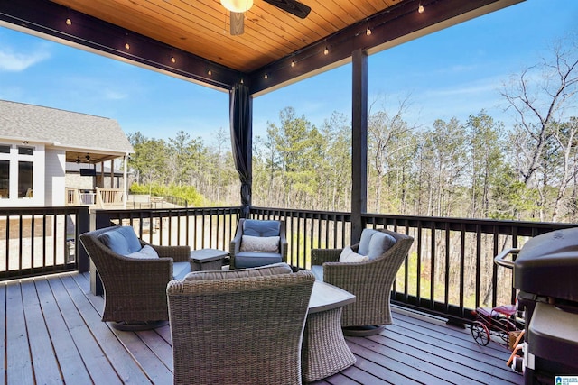 wooden deck with an outdoor living space, a ceiling fan, and a grill