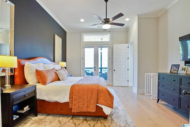 bedroom with light wood finished floors, ornamental molding, multiple windows, french doors, and access to outside