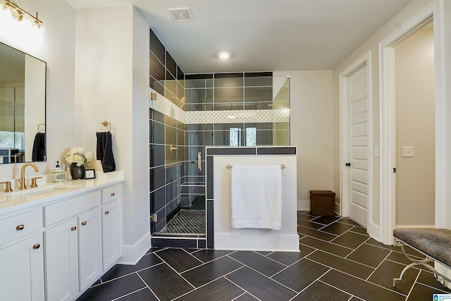 bathroom featuring visible vents, a shower stall, and vanity