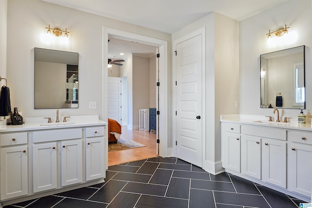 bathroom featuring a sink, two vanities, and a ceiling fan