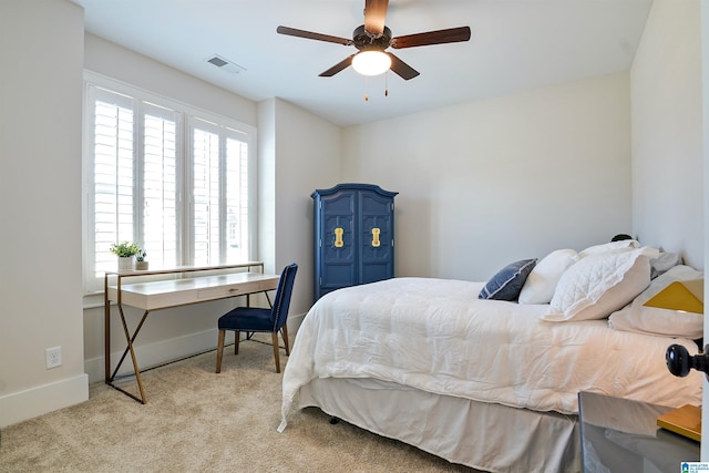 carpeted bedroom featuring visible vents, a ceiling fan, and baseboards