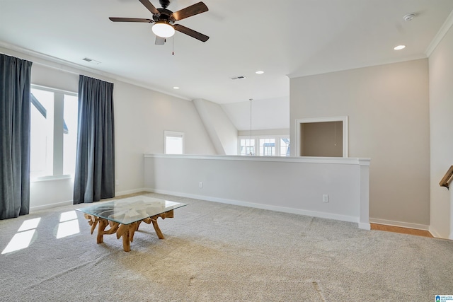 living area featuring visible vents, a healthy amount of sunlight, carpet flooring, and a ceiling fan