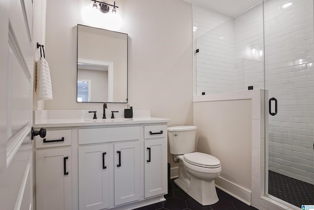 bathroom featuring vanity, toilet, a stall shower, and tile patterned flooring