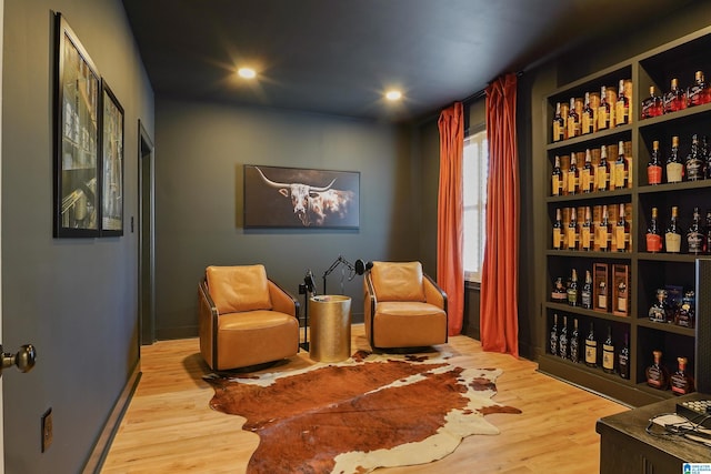 sitting room featuring recessed lighting, baseboards, and wood finished floors