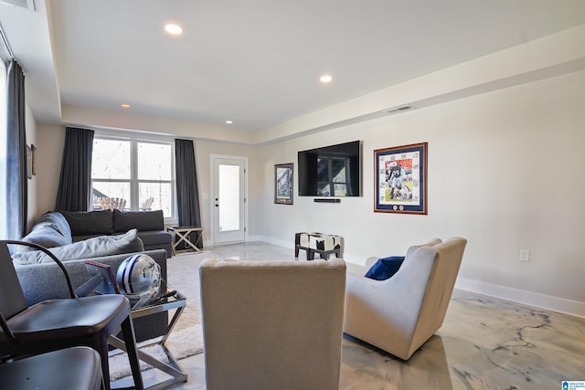 living area with recessed lighting, visible vents, and baseboards