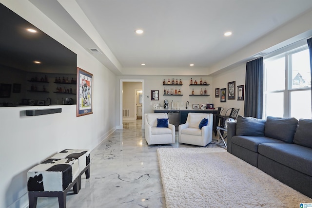 living room with indoor wet bar, visible vents, recessed lighting, and marble finish floor