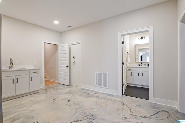 interior space with visible vents, recessed lighting, vanity, and baseboards