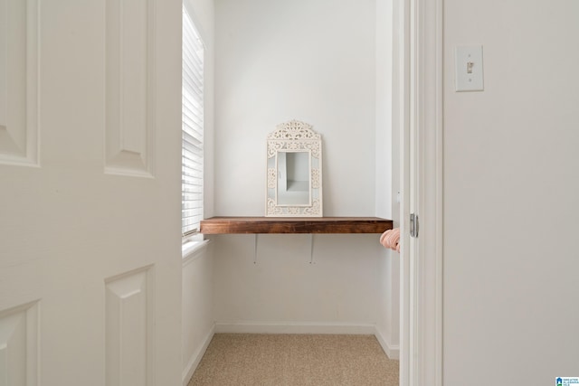 spacious closet featuring light colored carpet