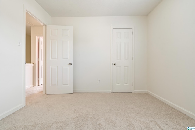 unfurnished bedroom with carpet and baseboards