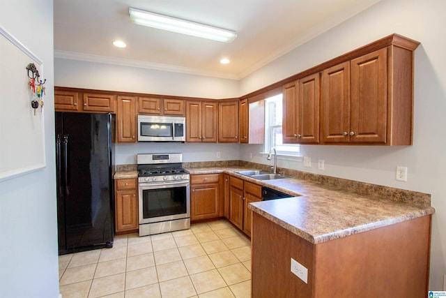 kitchen featuring light tile patterned floors, brown cabinets, appliances with stainless steel finishes, and a sink