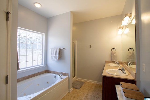 full bath featuring a shower stall, a jetted tub, double vanity, tile patterned floors, and a sink