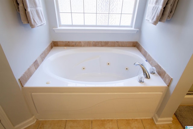 full bathroom featuring a wealth of natural light, tile patterned flooring, and a jetted tub