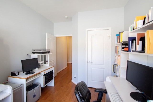 home office featuring baseboards and wood finished floors