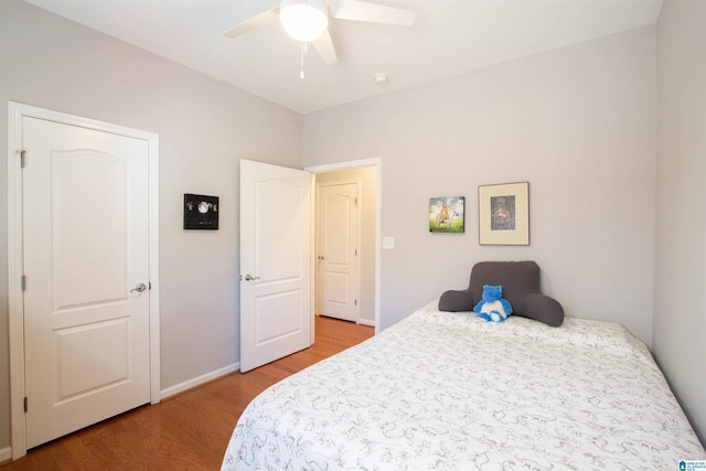 bedroom with light wood-style flooring, baseboards, and ceiling fan