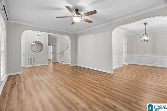 unfurnished living room featuring arched walkways and visible vents