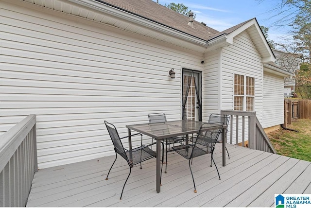 wooden deck with outdoor dining area and fence