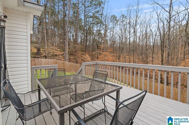 wooden deck featuring outdoor dining space and fence