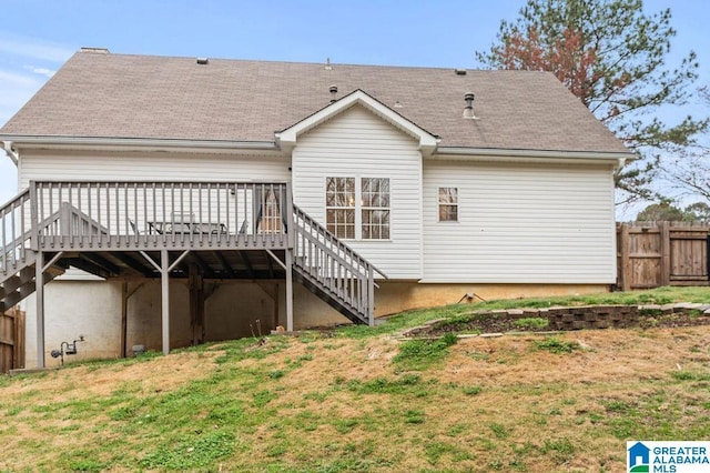 back of property with stairway, a lawn, a deck, and fence