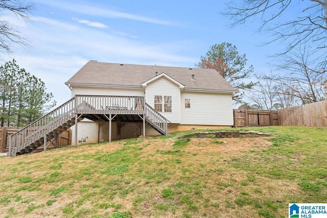 rear view of property featuring a yard, a deck, stairs, and a fenced backyard