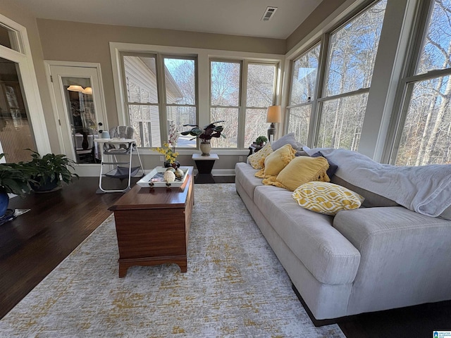 living room featuring visible vents and wood finished floors