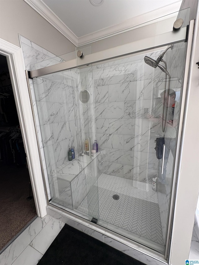 bathroom with crown molding, marble finish floor, and a marble finish shower