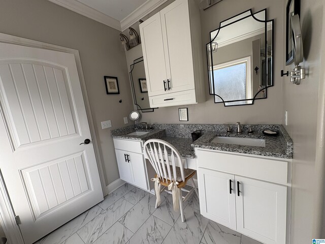 bathroom with baseboards, double vanity, a sink, crown molding, and marble finish floor