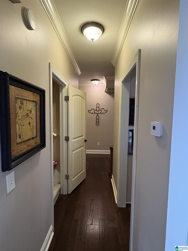 hall with baseboards, dark wood-style flooring, and ornamental molding