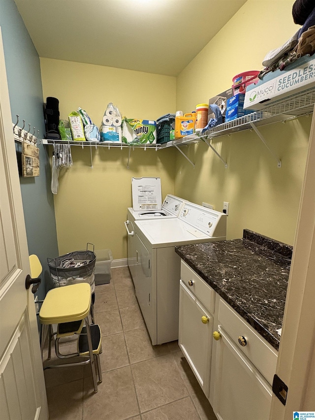 laundry area with light tile patterned floors and washing machine and clothes dryer