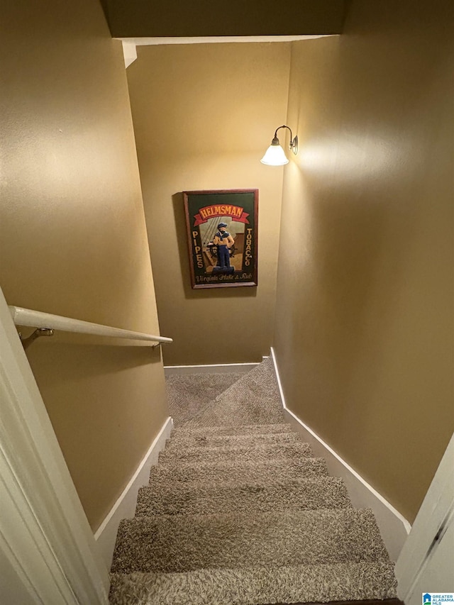 stairway with carpet flooring and baseboards