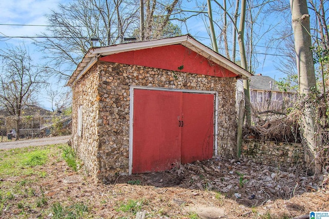 view of outdoor structure with an outbuilding and fence