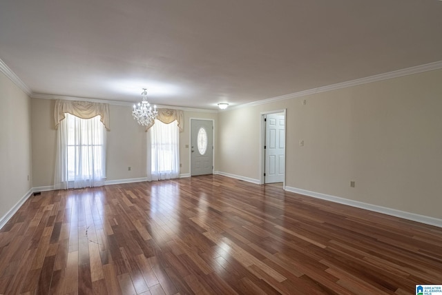 unfurnished living room with baseboards, dark wood-type flooring, a chandelier, and ornamental molding