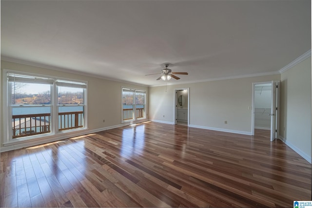 unfurnished room with a healthy amount of sunlight, a ceiling fan, and dark wood-style flooring