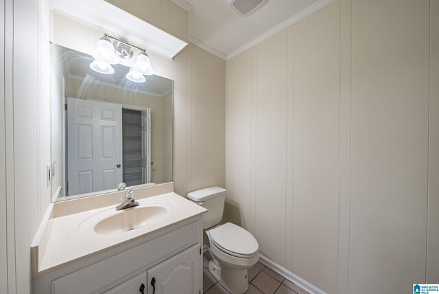 bathroom with visible vents, toilet, crown molding, a decorative wall, and vanity