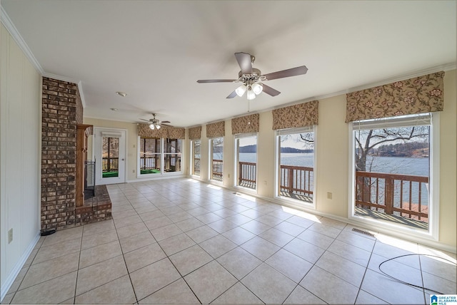 unfurnished sunroom with visible vents, a water view, and ceiling fan