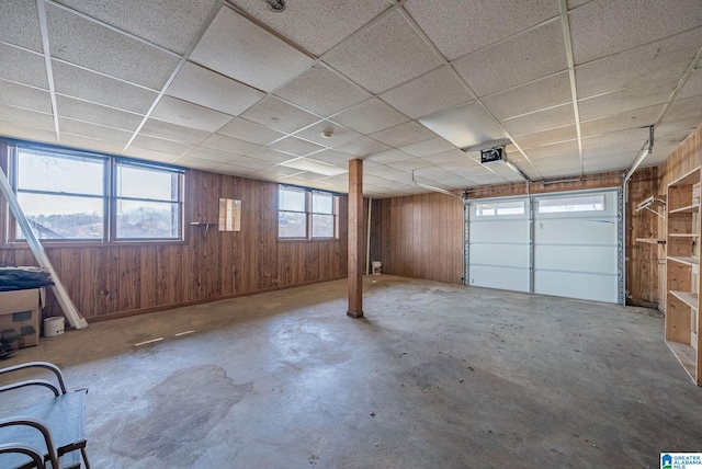 garage with wooden walls and a garage door opener